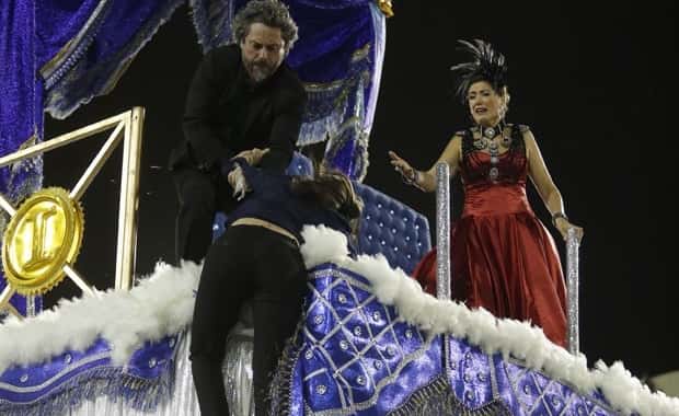Cora fica pendurada no carro alegórico que leva Zé e Marta (Foto: Artur Meninea/Gshow)