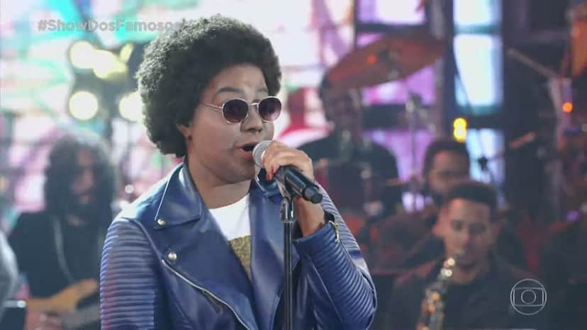 Ludmilla caracterizada ficou parecida com Arnold, do SBT, como Sandra de Sá no Show dos Famosos (Foto: Reprodução) Ludmilla caracterizada ficou parecida com Arnold, do SBT, como Sandra de Sá no Show dos Famosos (Foto: Reprodução)