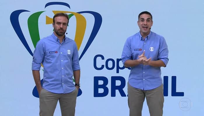 Roger Flores e Gustavo Villani foram chamados às pressas para transmissão ao vivo na Globo após problema com Luís Roberto (Foto: Reprodução/Globo) Roger Flores e Gustavo Villani foram chamados às pressas para transmissão ao vivo na Globo após problema com Luís Roberto (Foto: Reprodução/Globo)
