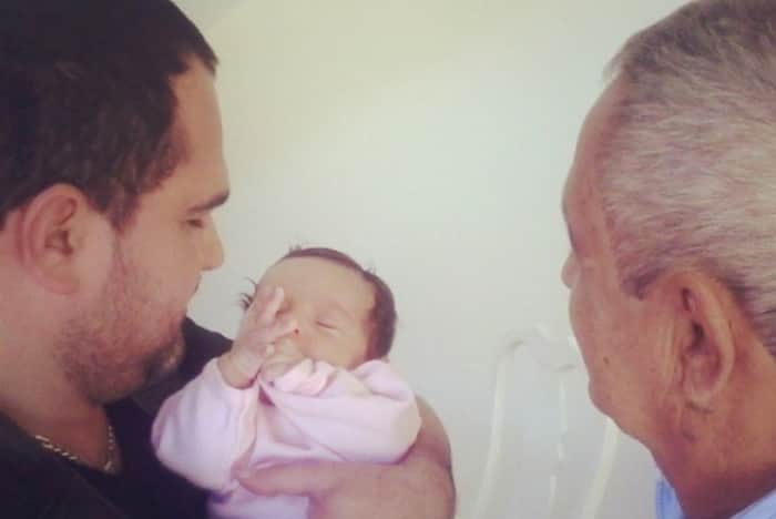 Luciano segurando a neta nos braços ao lado de seu pai, Francisco Luciano segurando a neta nos braços ao lado de seu pai, Francisco