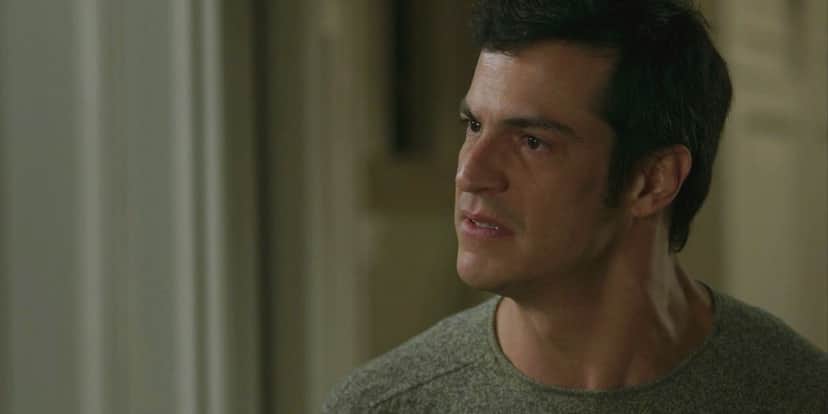 Eric usa camisa cinza e cabelo liso preto em cena de Pega Pega Eric usa camisa cinza e cabelo liso preto em cena de Pega Pega
