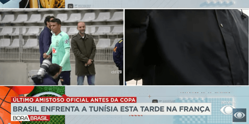 Momento em que o repórter é impedido de continuar a gravar por seguranças locais (Foto Reprodução/Band) Momento em que o repórter é impedido de continuar a gravar por seguranças locais (Foto Reprodução/Band)