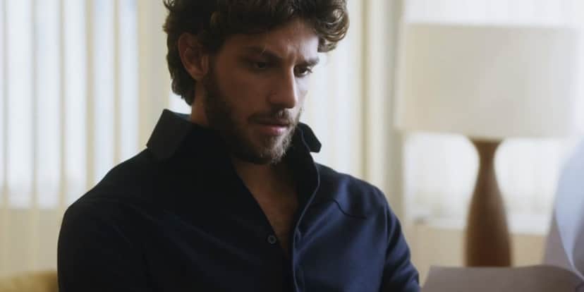 Ari em cena da novela Travessia segurando papéis Ari em cena da novela Travessia segurando papéis
