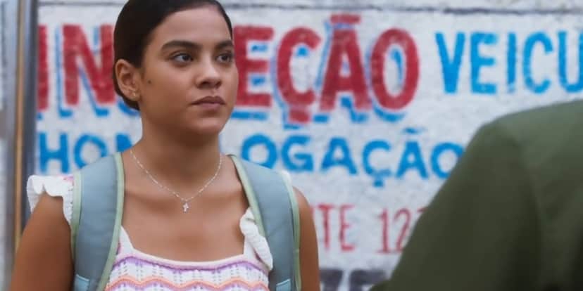 Jenifer em cena da novela Vai na Fé usando blusa listrada e mochila cinza Jenifer em cena da novela Vai na Fé usando blusa listrada e mochila cinza