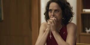 Núbia está sentada com as mãos apegada a terço na novela Travessia Núbia está sentada com as mãos apegada a terço na novela Travessia
