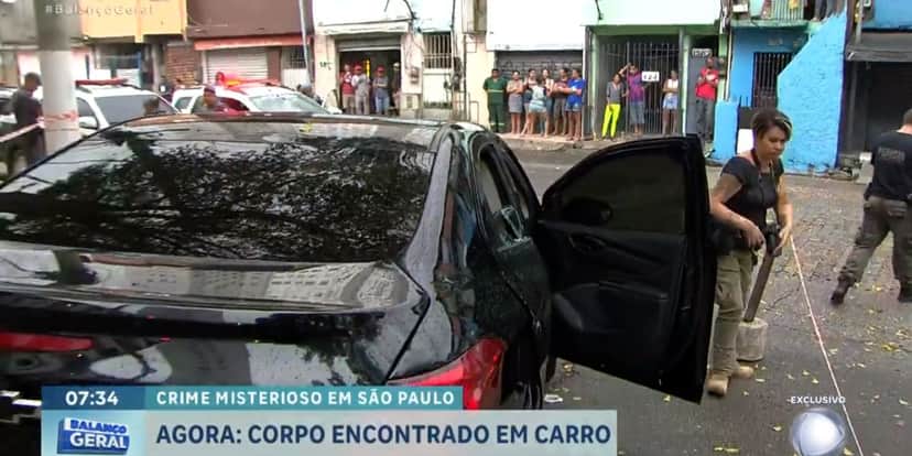 O corpo ainda estava dentro do carro quando a reportagem chegou (Reprodução: Record) O corpo ainda estava dentro do carro quando a reportagem chegou (Reprodução: Record)