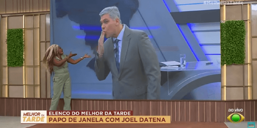 Joel Datena ao lado de Janaína Nunes (Foto: Reprodução/ YouTube/ Band/ Melhor da Tarde) Joel Datena ao lado de Janaína Nunes (Foto: Reprodução/ YouTube/ Band/ Melhor da Tarde)