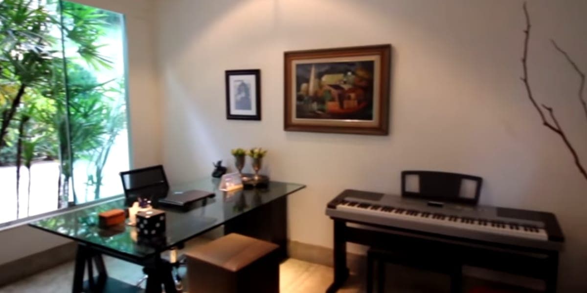 Escritório do artista, com um teclado e belos quadros na parede (Reprodução: Youtube) Escritório do artista, com um teclado e belos quadros na parede (Reprodução: Youtube)