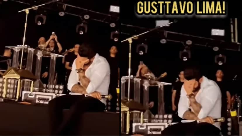 Momento que multidão grita música e Gusttavo LIma, sentado no chão do palco, leva as mãos ao rosto e chora Momento que multidão grita música e Gusttavo LIma, sentado no chão do palco, leva as mãos ao rosto e chora